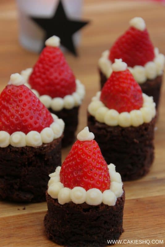 Santa Hat Brownies | These Santa Hat Brownies are super cute and easy to make. A perfect Christmas recipe. Everyone will love these rich brownies topped with strawberries. | http://www.cakieshq.com